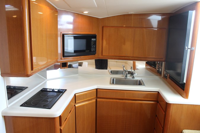 Spacious galley with high gloss varnished teak