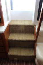 Carpeted stairs with stowage under