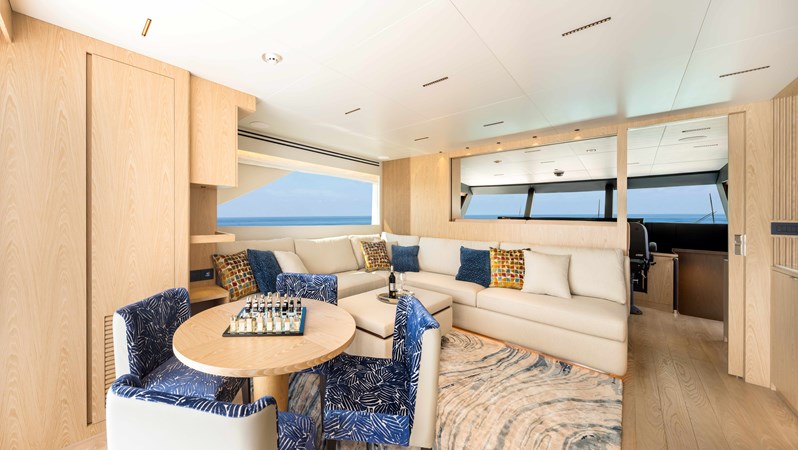 Horizon FD110 Hull 7 Skylounge with card table, TV and large sofa.