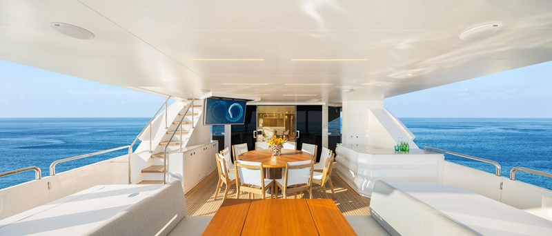 Horizon FD110 Hull 7 Aft Deck with round formal dining and seating.