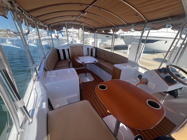 Movable teak table integrated with two drink holders