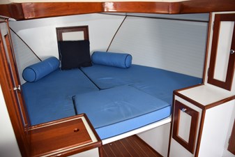 Open V-berth with filler cushion, wood trim