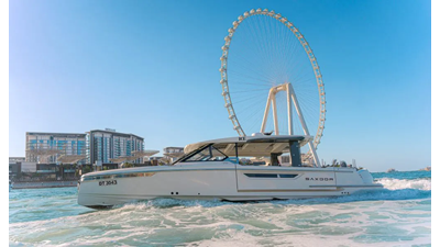 Saxdor 400 GTO ICE yacht cruising in Dubai Marina with Ain Dubai Ferris Wheel in the background.