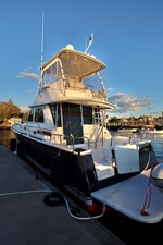 DEFY GRAVITY, 2018 Sabre 48 Flybridge Sedan, Port Quarter at Dock