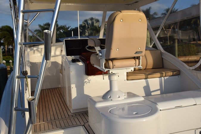 Teak decking on bridge deck and aft facing bench seat to right of helm. - Copy
