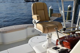 Fully adjustable Stidd helm chair with live well just behind.