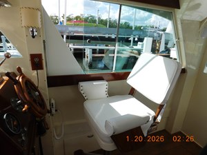Starboard salon with Ladderback helm Chair at lower helm