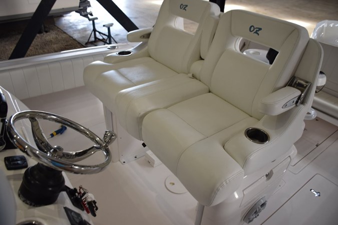Ocean Elite helm seat console with fold-down armrests and drink holders.