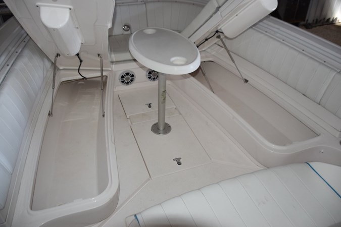 Larger storage compartments accessed with gas shock lifts beneath forward seating bases