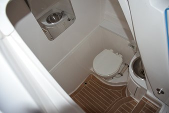 Raritan electric head, stainless steel sink with faucet, shower wand, and drained sole with SeaDek, mirror.