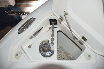 Electric anchor windlass with safety lanyard and thru-hull chute - stainless claw anchor, chain lead and nylon rode. Switches here