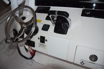 Tiltable helm wheel Yamaha control binnacle and digital engine display, bow thruster and trim tab controls.
