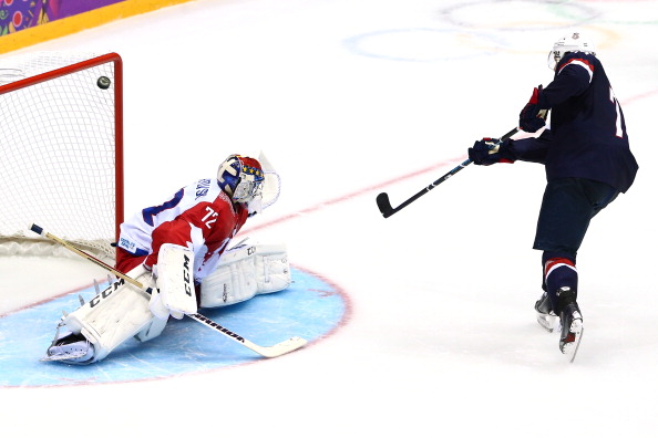 SOCHI, RUSSIA - FEBRUARY 15: T.J. Oshie #74 of the United States scores on a shootout against Sergei Bobrovski #72 of Russia during the Men's Ice Hockey Preliminary Round Group A game on day eight of the Sochi 2014 Winter Olympics at Bolshoy Ice Dome on February 15, 2014 in Sochi, Russia. (Photo by Clive Mason/Getty Images)