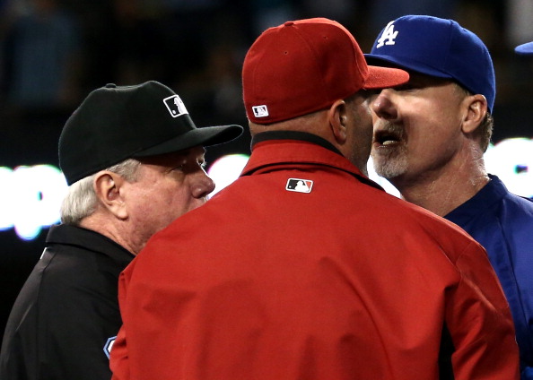 LOS ANGELES, CA - JUNE 11: Batting coach Mark McGwire (R) of the Los Angeles Dodgers has words with manager Kirk Gibson of the Arizona Diamondbacks as first base umpire Brian Gorman intervenes during a bench clearing brawl in the seventh inning at Dodger Stadium on June 11, 2013 in Los Angeles, (Photo by Stephen Dunn/Getty Images)