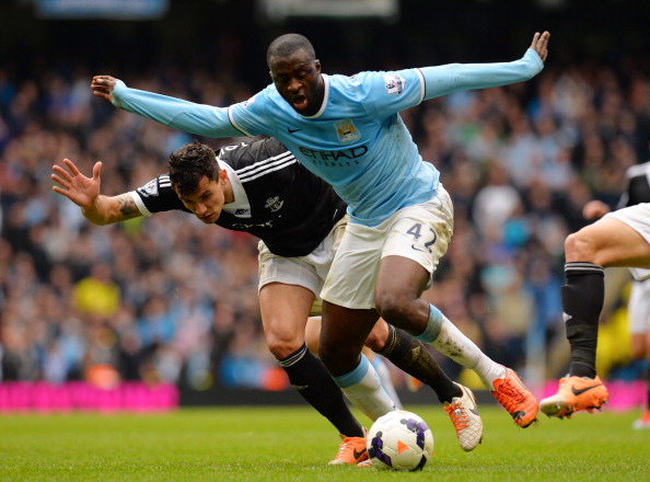 MANCHESTER, ENGLAND - APRIL 05: Yaya Toure of Manchester City is challenged by Jose Fonte of Southampton during the Barclays Premier League match between Manchester City and Southampton at Etihad Stadium on April 5, 2014 in Manchester, England. (Photo by Shaun Botterill/Getty Images)