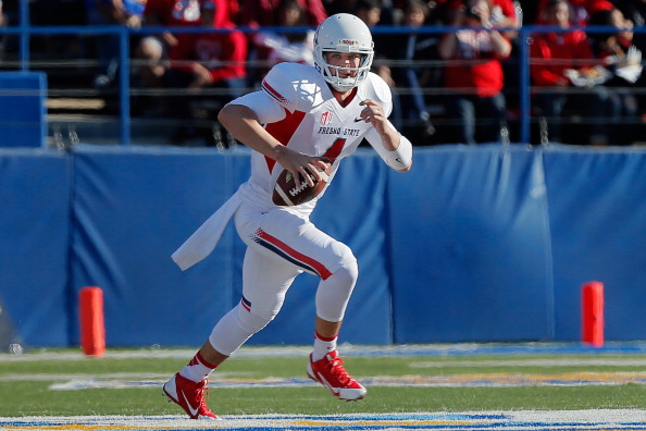 SAN JOSE, CA - NOVEMBER 29: Quarterback Derek Carr #4 of the Fresno State Bulldogs picks up 12 yards and a first down as he holds on to the ball against the San Jose State Spartans in the first quarter on November 29, 2013 at Spartan Stadium in San Jose, California. The Spartans won 62-52. (Photo by Brian Bahr/Getty Images)