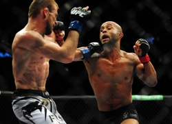 Jun 14, 2014; Vancouver, British Columbia, Canada; Demetrious Johnson (red) fights against Ali Bagautinov (blue) in the flyweight title bout at UFC 174 at Rogers Arena. Mandatory Credit: Anne-Marie Sorvin-USA TODAY Sports