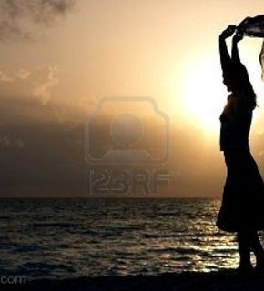 1415078-silhouette-of-young-girl-dancing-on-the-beach-at-sunset_medium