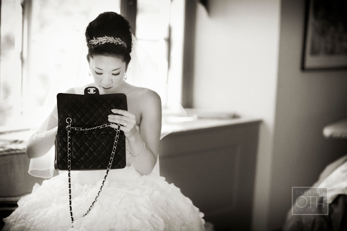 Bride with purse at Hudson Valley wedding at Cat Rock in Garrison, NY  - Glen Allsop of Christian Oth Studio