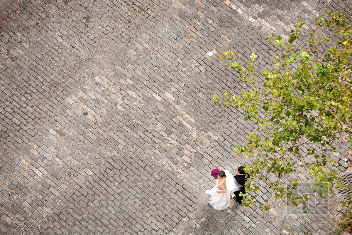 bride and groom from above on cobblestone - Christian Oth of Christian Oth Studio
