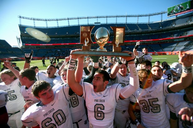 Pine Creek players celebrate with the 4A championship trophy. (Kai Casey/CHSAANow.com)