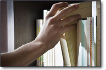 Hand reaching for book