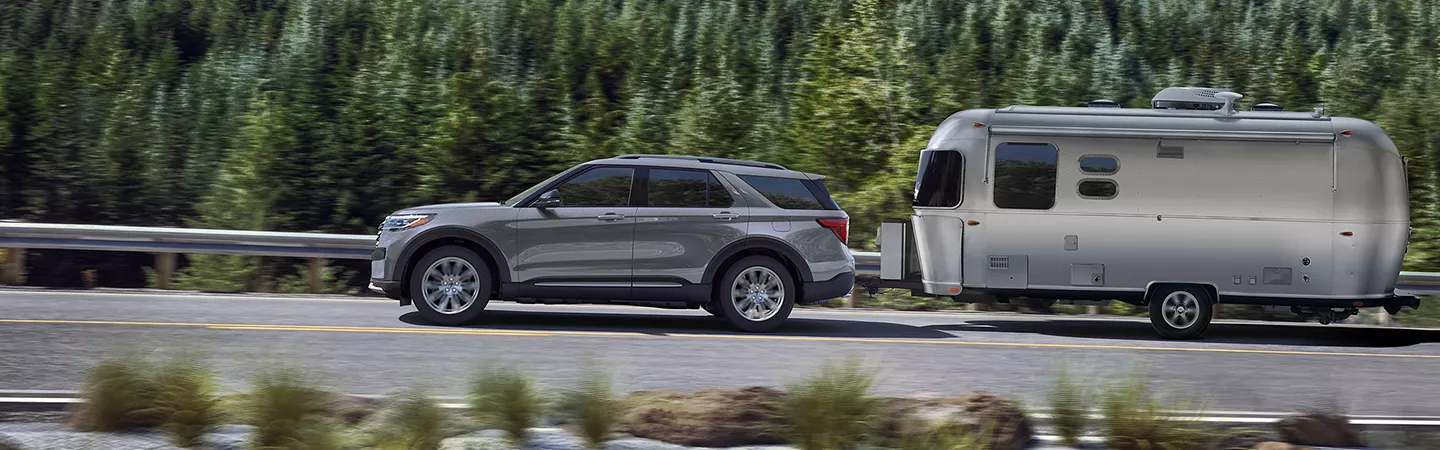 2026 Ford Explorer towing an Airstream trailer behind it in the wilderness