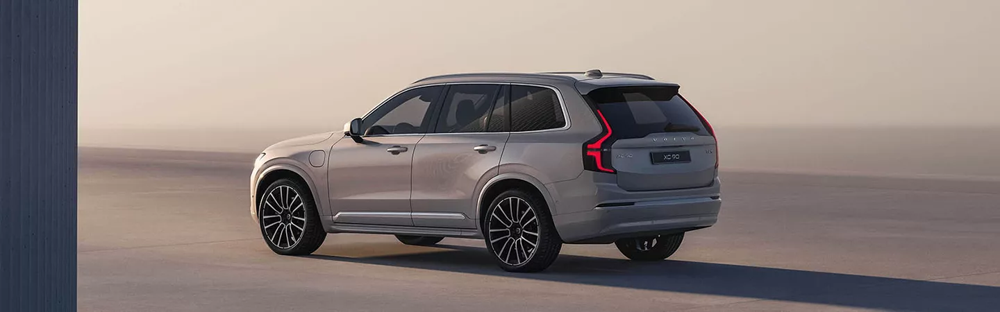 Side view of 2026 Volvo XC90 parked in a modern abstract setting