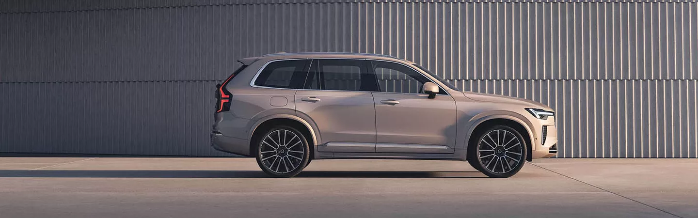 Side view of 2026 Volvo XC90 parked in a modern abstract setting