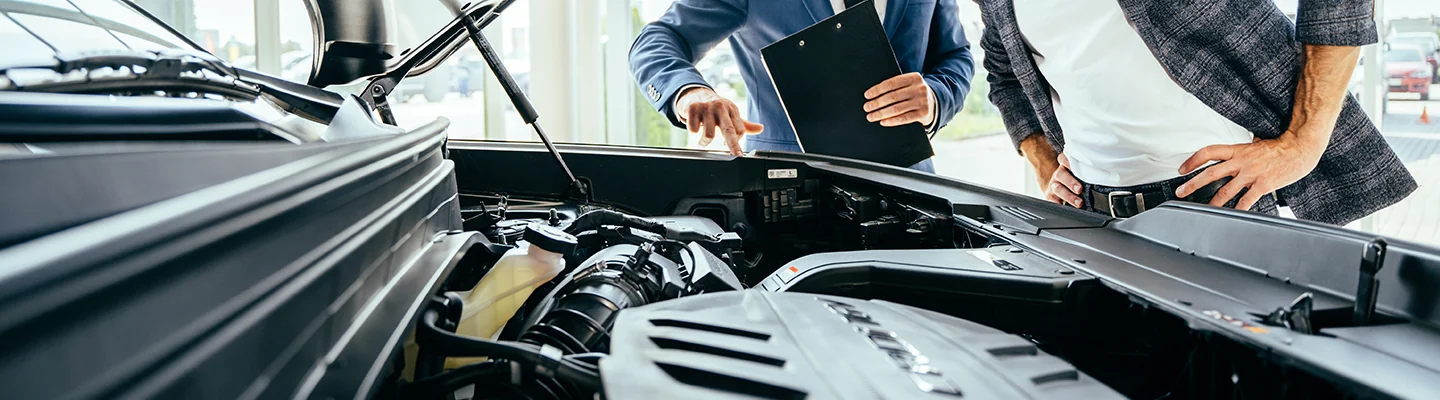 2 car mechanics working around and open car hood and engine