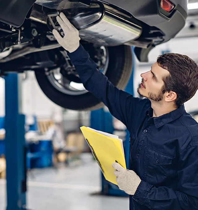 Service tech working under a car