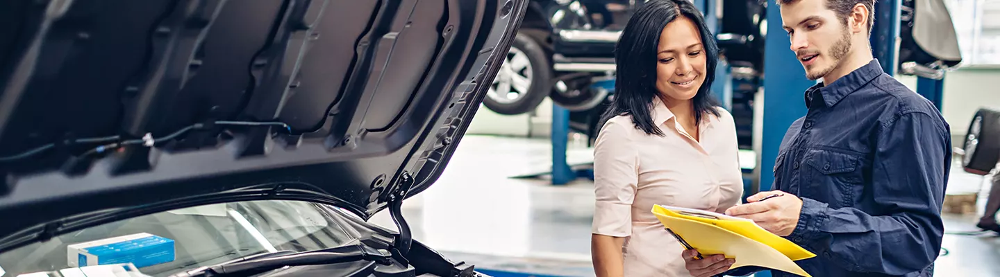 Woman reviewing service options for her Vehicle at CDJR of Tampa Bay