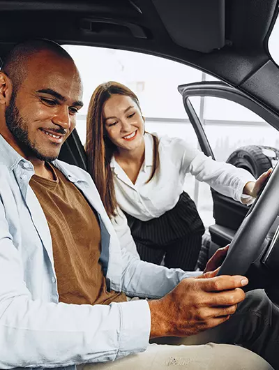 showing customer new car in showroom