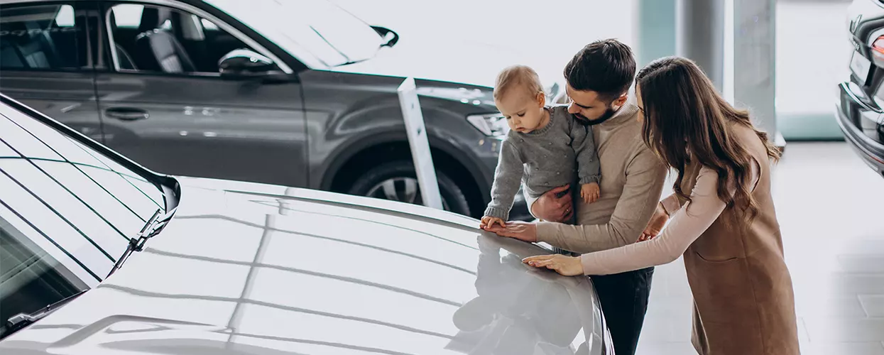 Family looking at a new vehicle at a Jaguar dealership