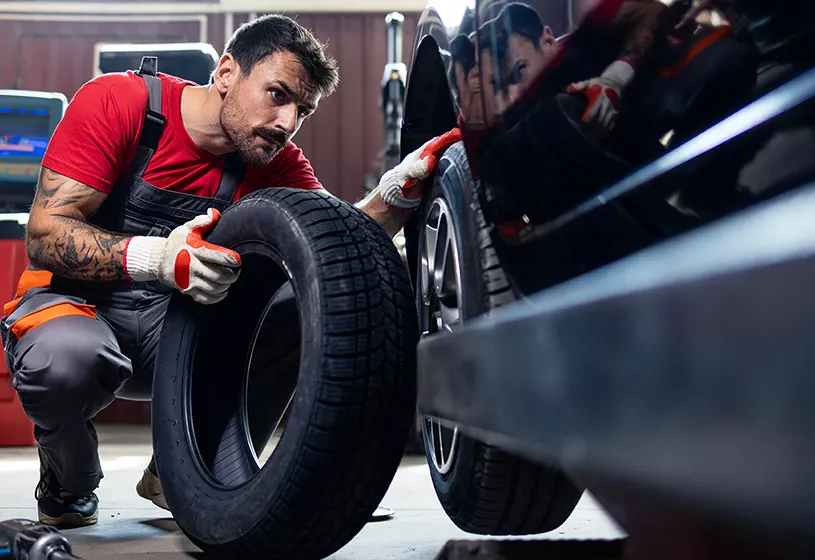 Service mechanic working on tires