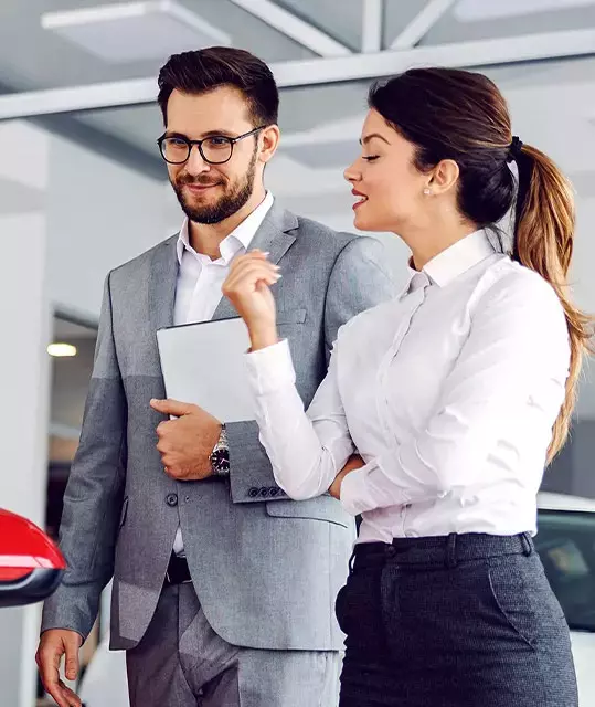 Customers reviewing vehicle financing information