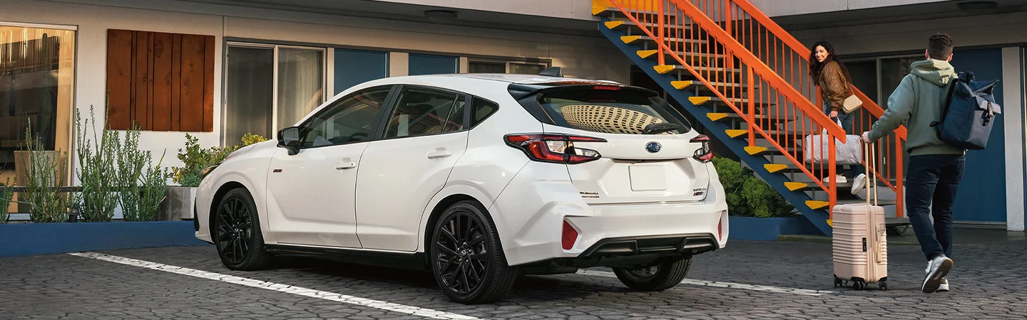 2025 Subaru Impreza parking on home white color car with standing man in Chattanooga, TN