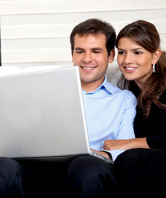 two people looking at computer for cars