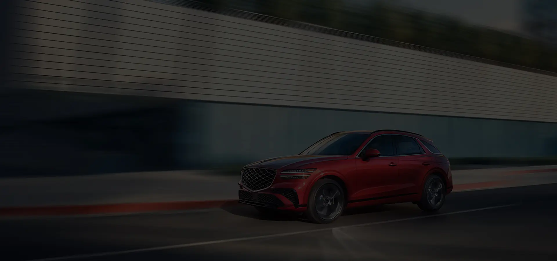red brand new Genesis touring on blacktop in day time