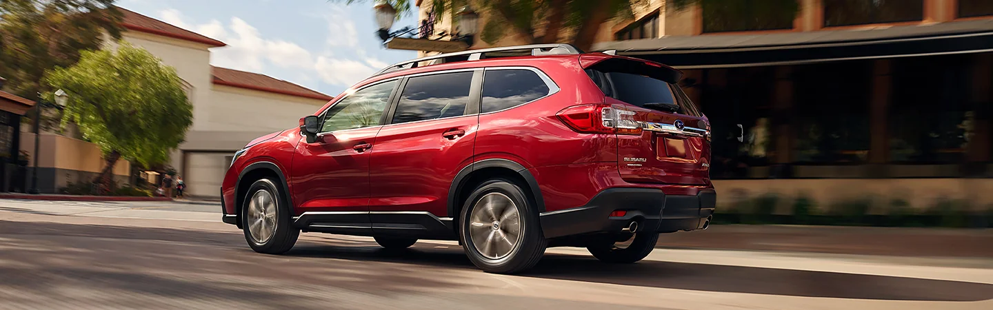 back side view of a 2025 Subaru Ascent driving though the city