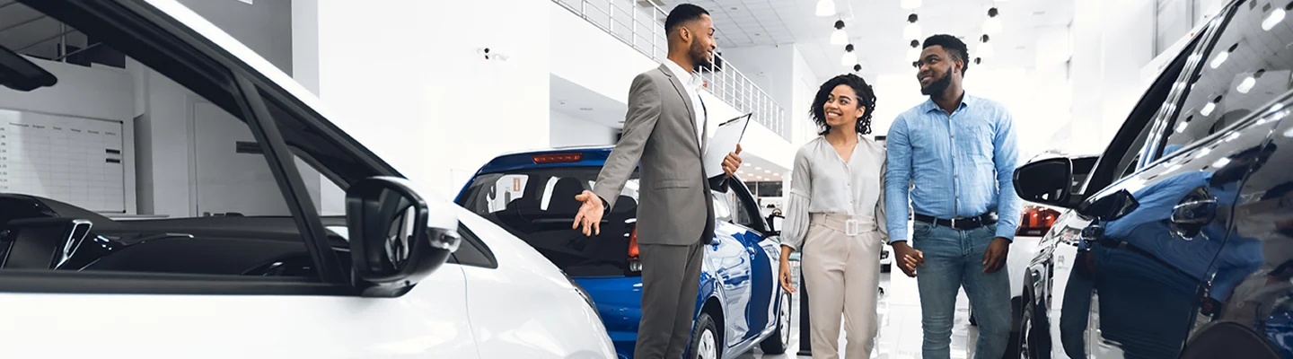 Folks talking with saleperson in dealer