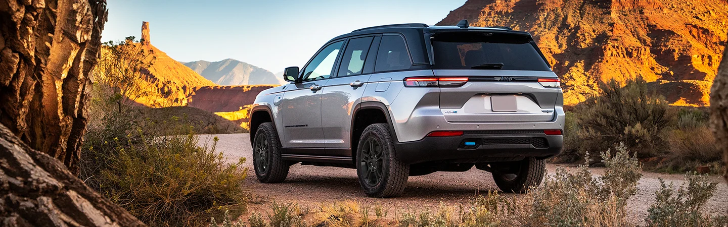 Back side view of a 2025 Jeep Grand Cherokee parked in the desert
