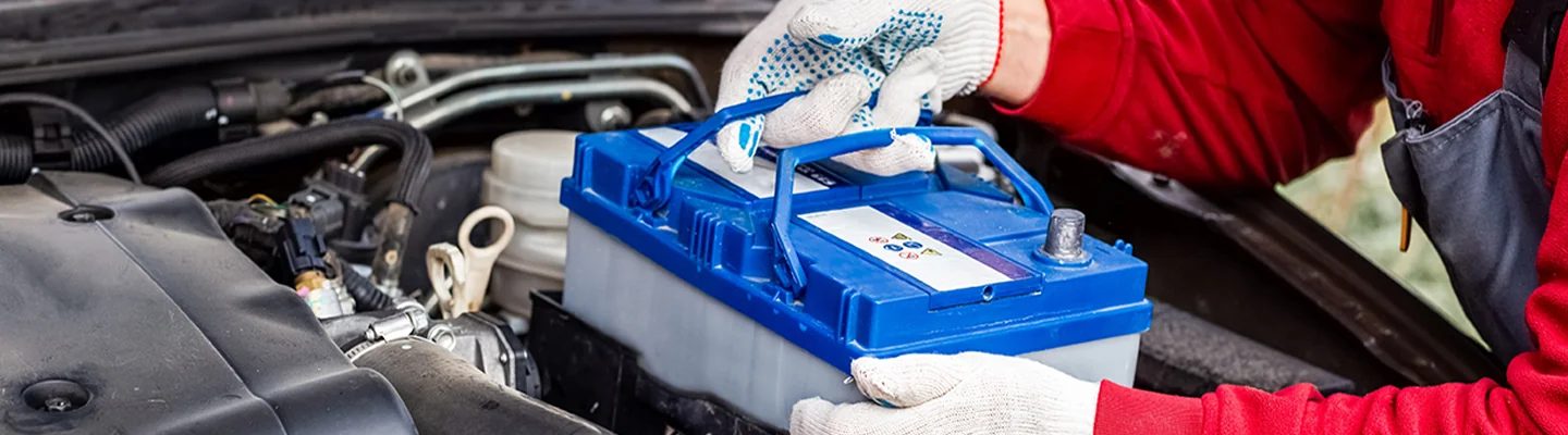 auto mechanic replacing battery at Colonial Volkswagen