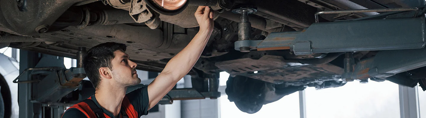 Service technician working on a Kia vehicle