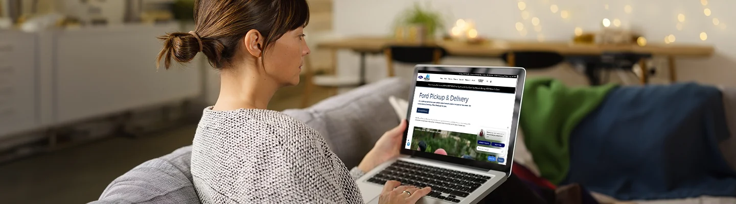 person on a computer shoping for cars by browsing Marlow Ford's websiie