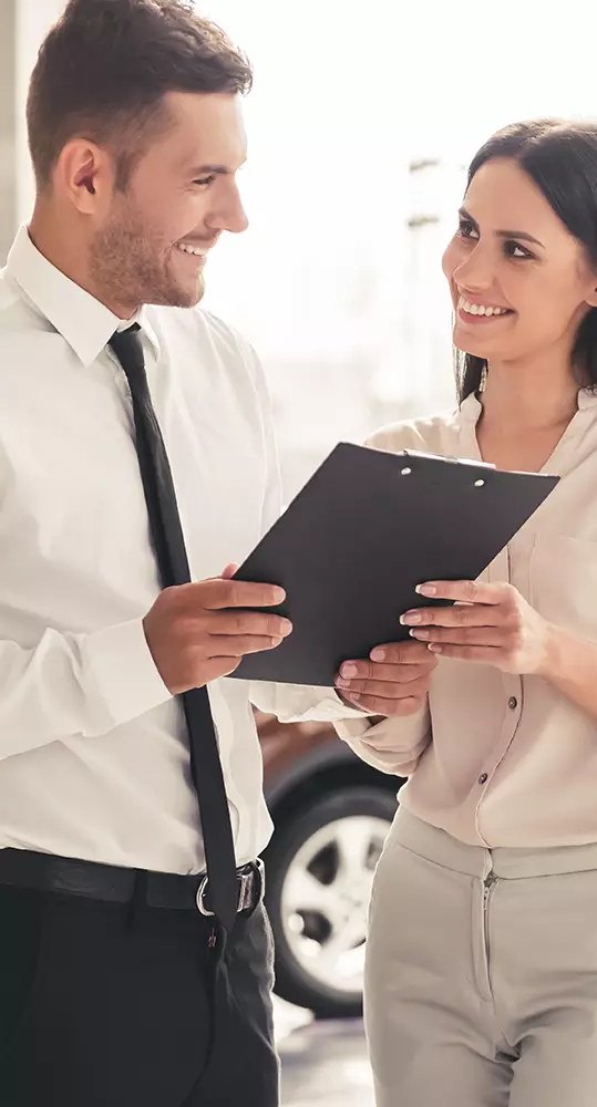 Customers reviewing vehicle financing information