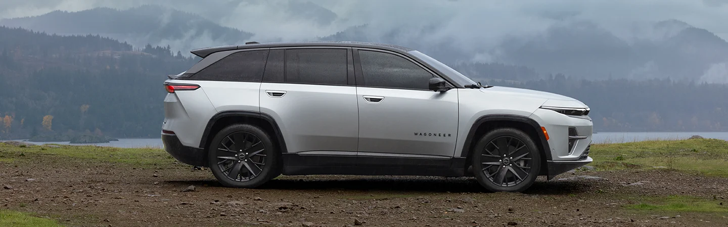 2025 Wagoneer S Sliver color car parked on grass background moutaion view