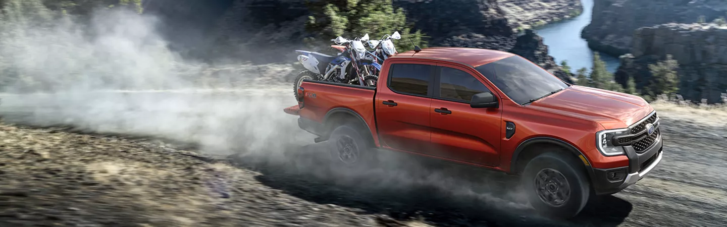 2025 Ford Ranger driving on a country road in the rain
