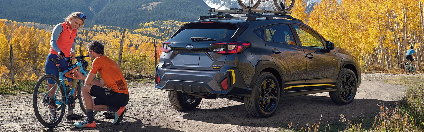 2025 Subaru Crosstrek Black color car back side man and woman repairing cycle