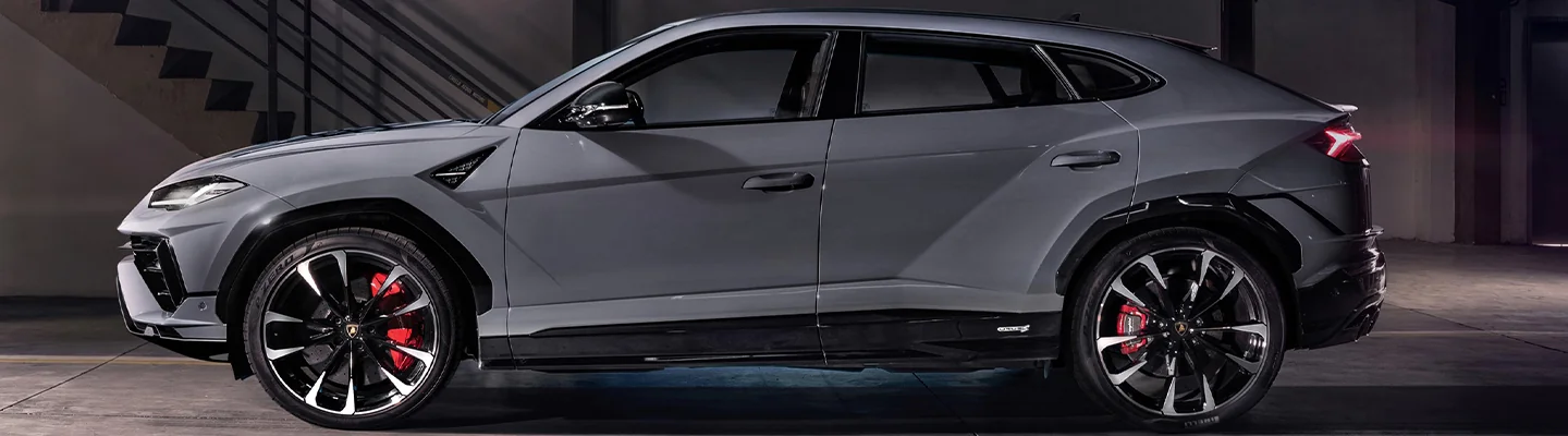 a side view of a silver Lamborghini Urus